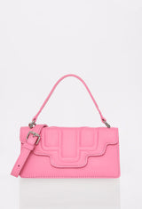 Front of a Pink Leather Crossbody Flap Bag Hilda with a raised design flap, Lazaro logo and a removable and adjustable strap.