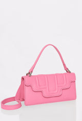 Side of a Pink Leather Crossbody Flap Bag Hilda with a raised design flap, Lazaro logo and a removable and adjustable strap.