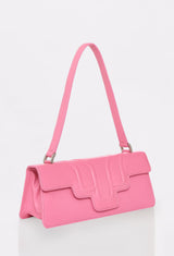 Side of a Pink Leather Shoulder Flap Bag Hilda with a raised design flap and Lazaro logo.