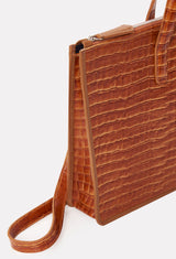 Partial photo of a Tan Croco Leather Slim Briefcase with a detachable leather strap and a main zippered compartment.