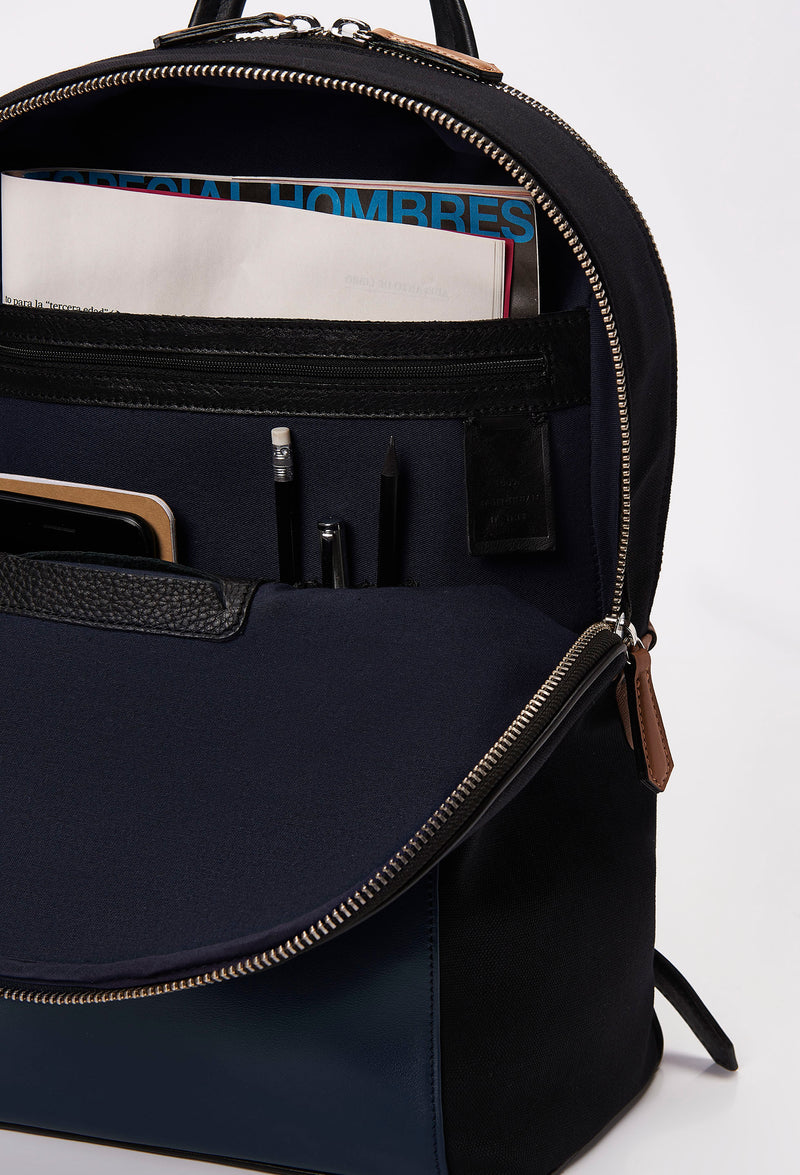 Partial photo of a Black Canvas and Leather Backpack with Laptop Compartment that shows internal multifunctional pockets.