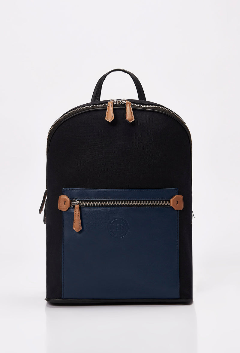 Front of a Black Canvas and Leather Backpack with blue and tan leather details, main compartment, Lazaro logo and front multifunctional pockets.