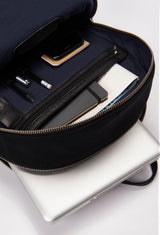 Interior of a Black Canvas and Leather Backpack that shows a main compartment with a zippered pocket and a cell phone pocket, and a special zippered and padded compartment for a computer.