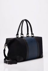 Side of a Black Canvas and Leather Duffel Bag with a blue leather strap, Lazaro logo, leather handles and a detachable shoulder strap.