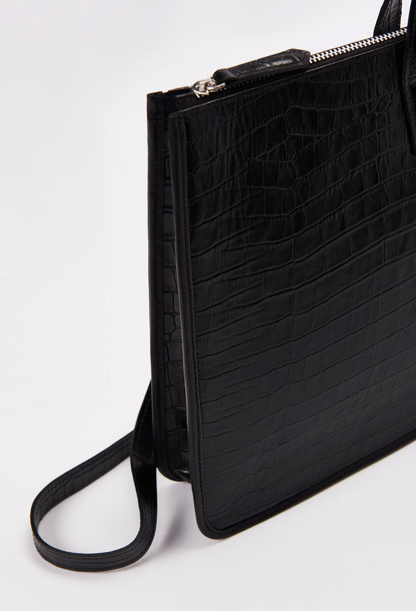 Partial photo of a Black Croco Leather Slim Briefcase with a detachable leather strap and a main zippered compartment.
