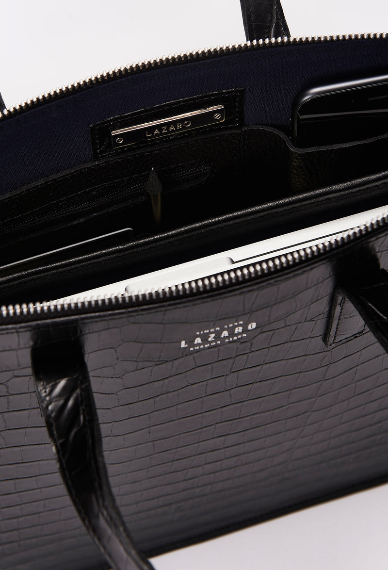 Interior photo of a Black Croco Leather Slim Briefcase showing its main zippered compartment packed with a computer, internal multifunctional pockets and Lazaro silver ironwork.