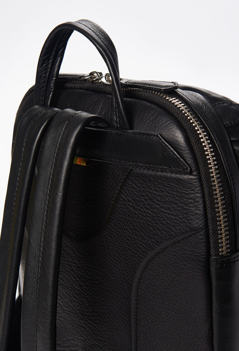 Partial photo of a Black Leather Backpack with ergonomically shaped rear, leather padded and adjustable straps.