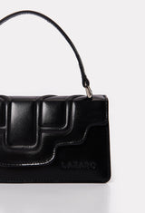Partial photo of a Black Leather Crossbody Flap Bag Hilda with a raised design flap and Lazaro logo.