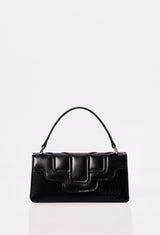 Front of a Black Leather Crossbody Flap Bag Hilda with a raised design flap and Lazaro logo.