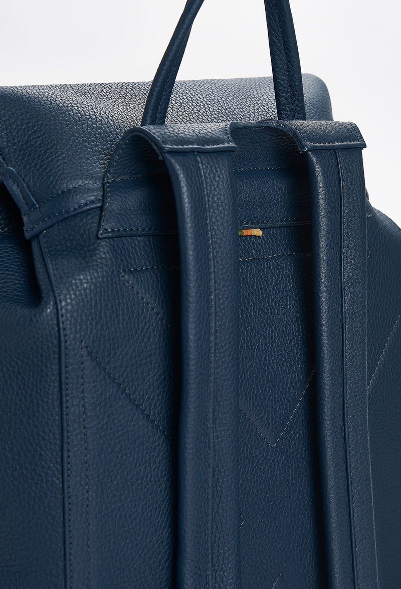 Partial photo of a Blue Large Leather Backpack with Buckle Closure showing its ergonomically shaped rear, leather padded and adjustable straps and a hidden zippered pocket.