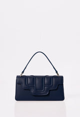 Front of a Blue Leather Crossbody Flap Bag Hilda with a raised design flap and Lazaro logo.