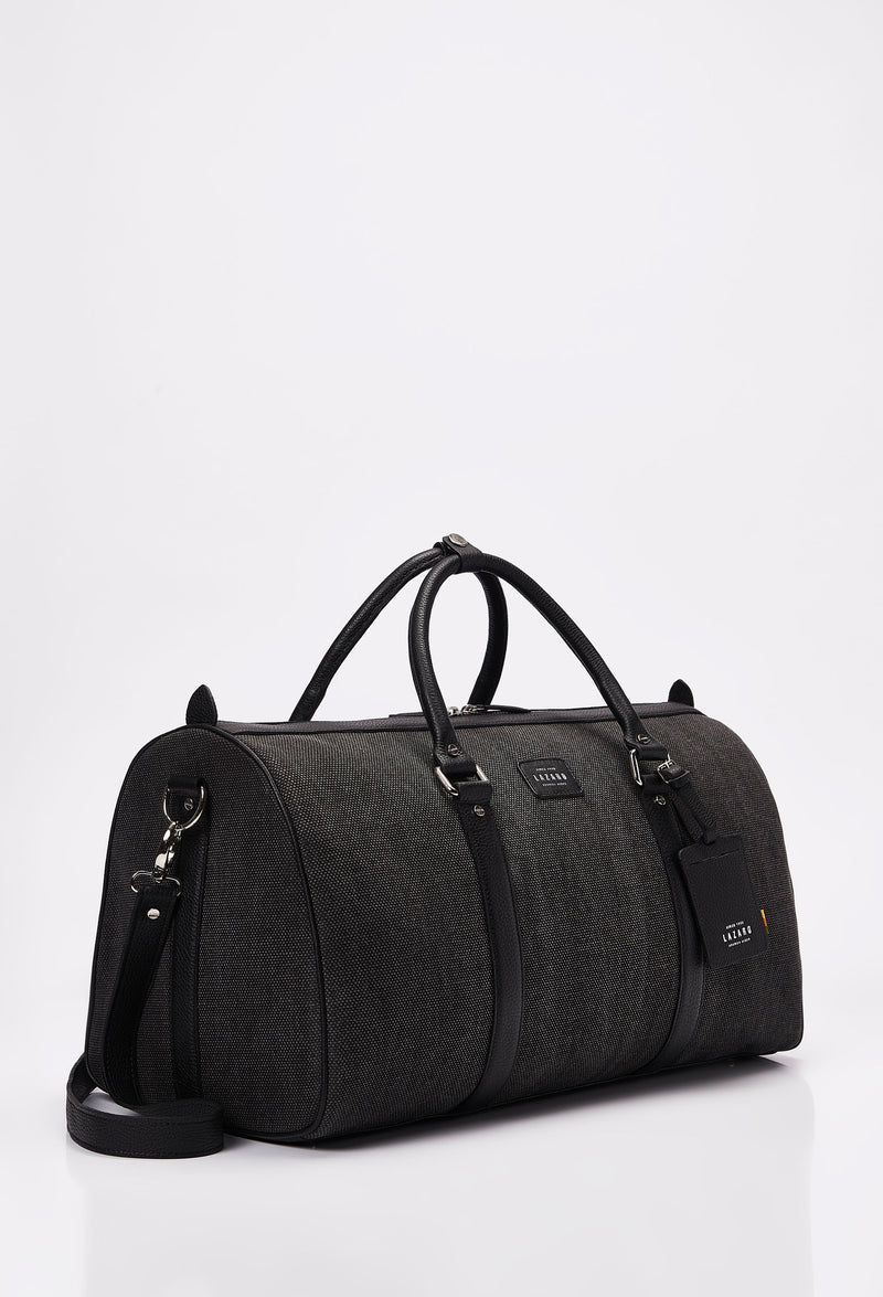 Side of a Canvas Duffel Bag with Lazaro logo, leather id, leather handles and a detachable shoulder strap.