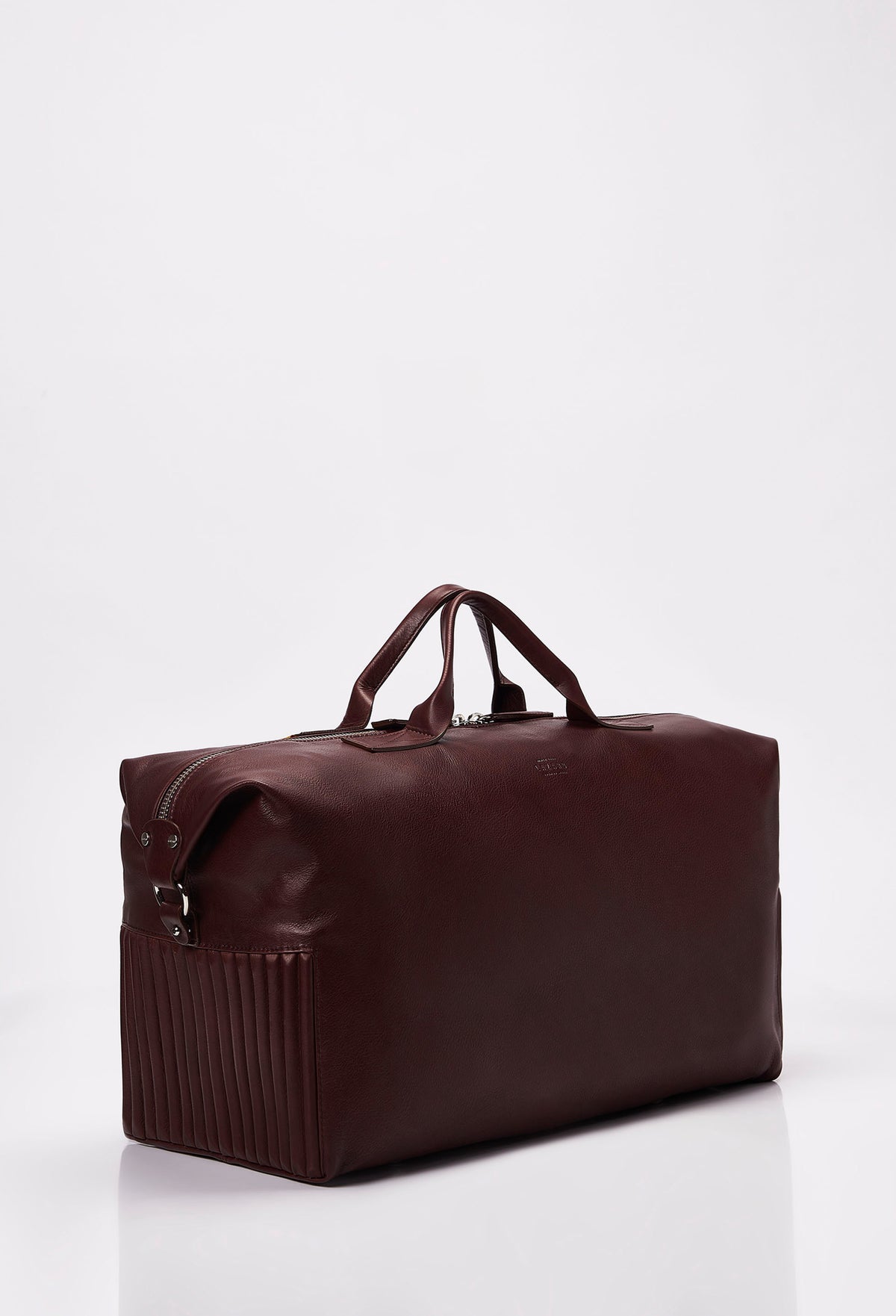 Side of a Coffee Leather Duffel Bag with side needlework, Lazaro logo and a main zippered compartment.