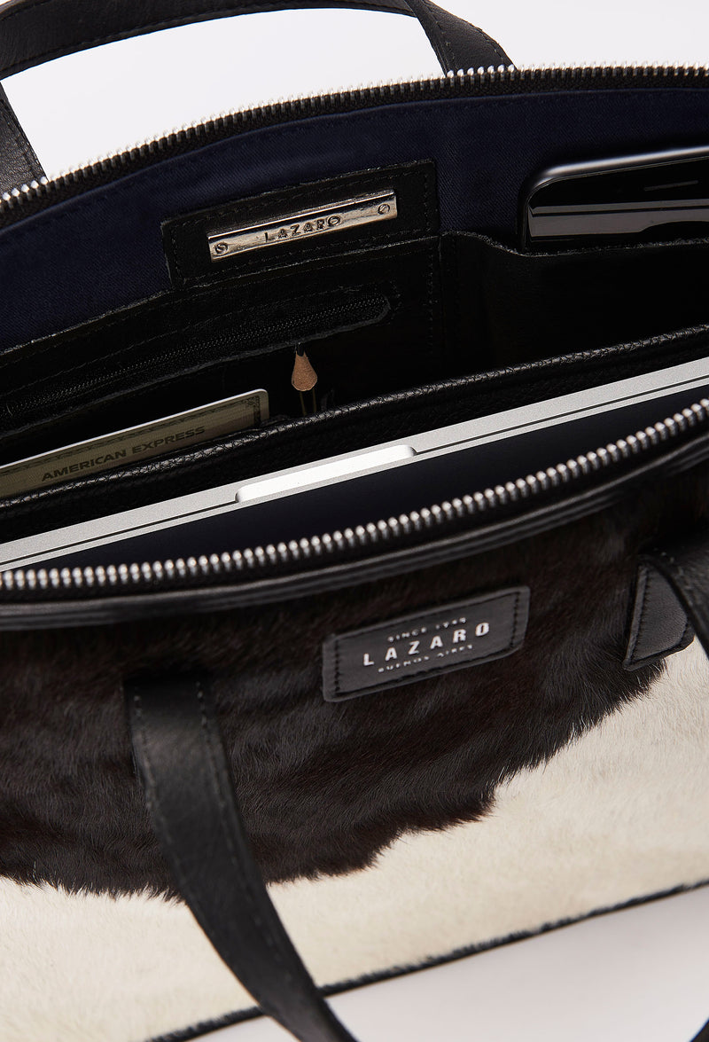Interior photo of a Cowhide Leather Slim Briefcase showing its main zippered compartment packed with a computer, internal multifunctional pockets and Lazaro silver ironwork.