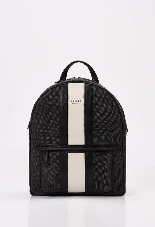 Front of a Lightweight Canvas Backpack made from distressed Panama canvas with Nappa leather trims in black and off white. It has the Lazaro logo and a front zippered pocket.