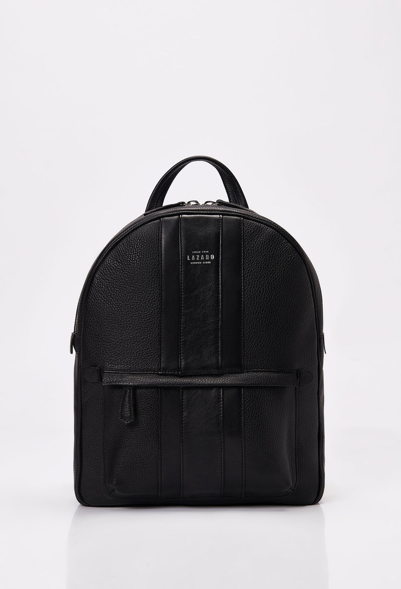 Front of a Leather Backpack made from black Full-Grain pebbled leather with Nappa leather trims in black. It has the Lazaro logo and a front zippered pocket.
