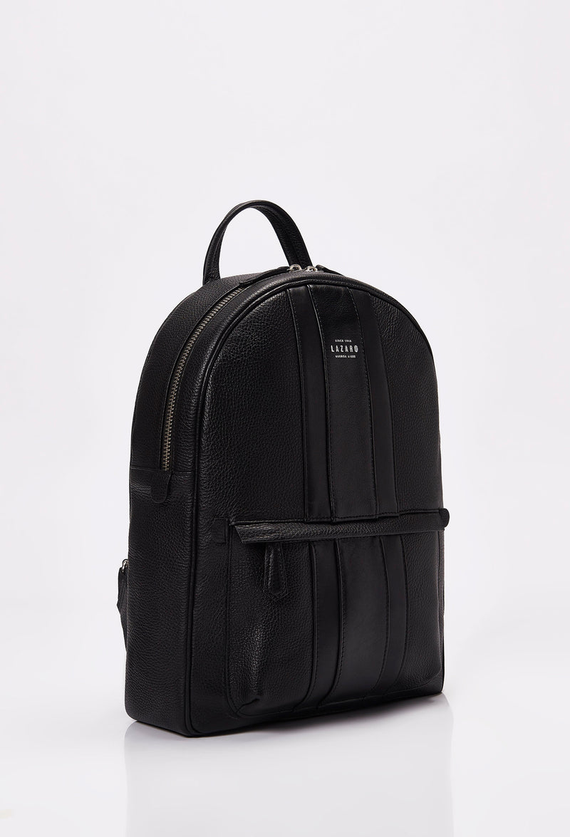 Side of a Lightweight Leather Backpack made from black Full-Grain pebbled leather with Nappa leather trims in black. It has a main zippered compartment, the Lazaro logo and a front zippered pocket.