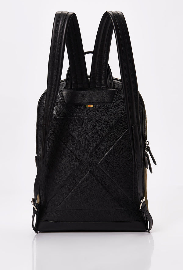 Rear of a Olive Canvas and Leather Backpack ergonomically shaped with leather details and padded and adjustable straps.