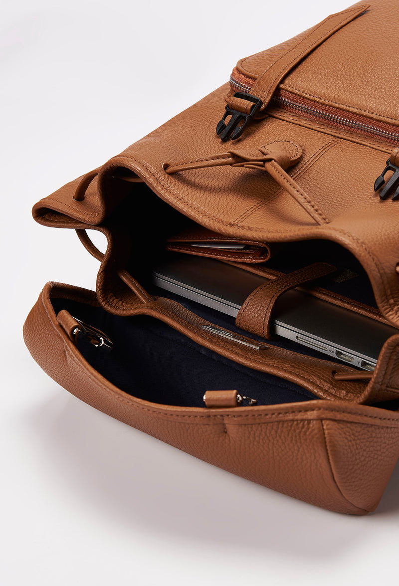Interior of a Tan Large Leather Backpack with Buckle Closure that shows a main compartment with a Lazaro wallet and a special compartment for a computer.