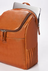Partial photo of a Tan Leather Backpack that shows a special zippered and padded compartment for a computer, side needlework, a main zippered compartment and a front multifunctional pocket.