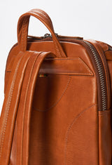 Partial photo of a Tan Leather Backpack with ergonomically shaped rear, leather padded and adjustable straps.