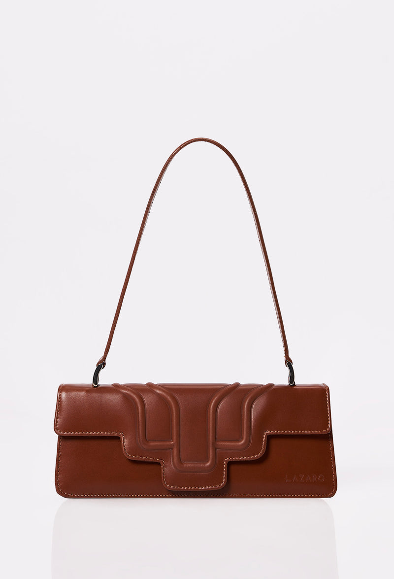 Front of a Tan Leather Shoulder Flap Bag Hilda with a raised design flap and Lazaro logo.
