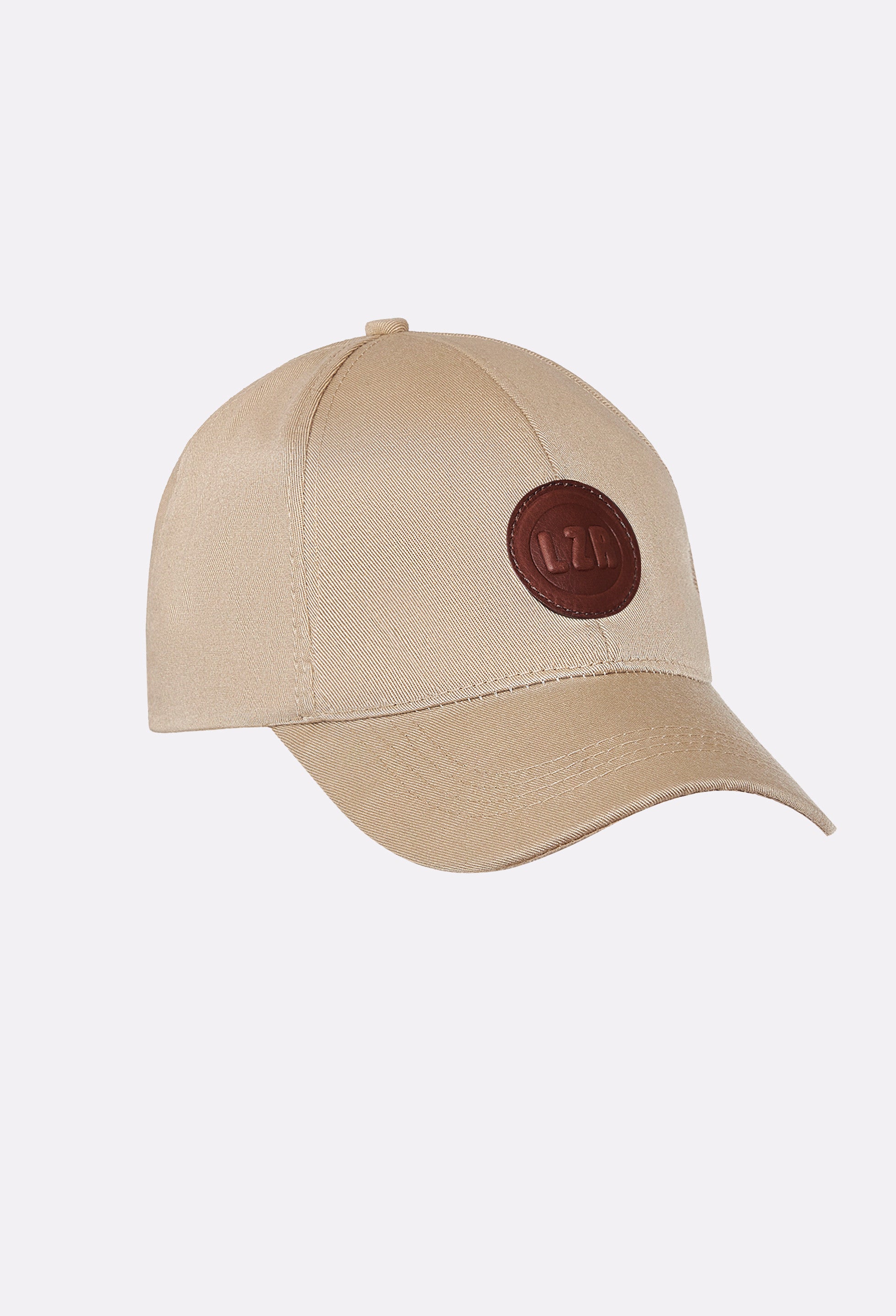 Front of a Beige Baseball Cap with a Patched Leather Lazaro Logo.