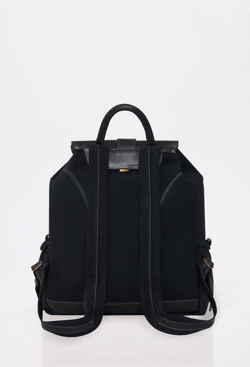 Rear of a Black Canvas Backpack with leather details and padded and adjustable straps.