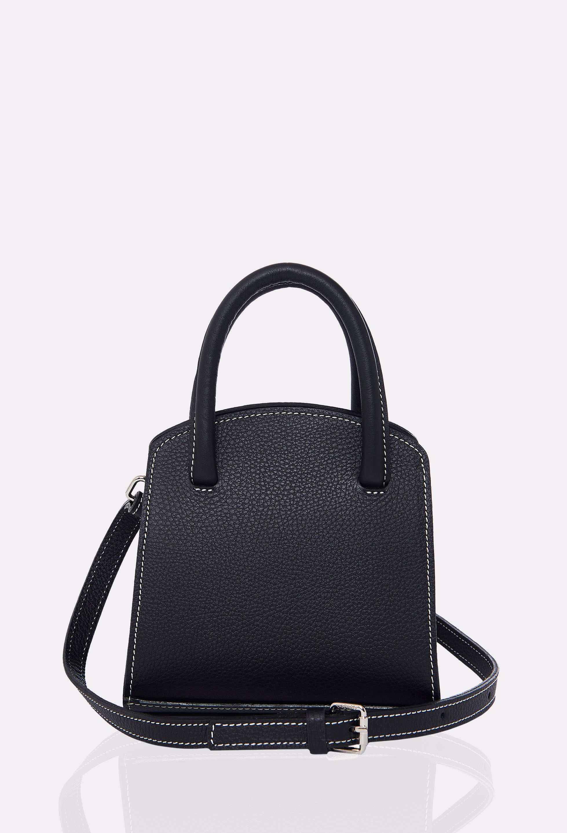 Rear of a Black Leather Mini Bag Margot with a leather adjustable and detachable strap and contrast stitching highlights.