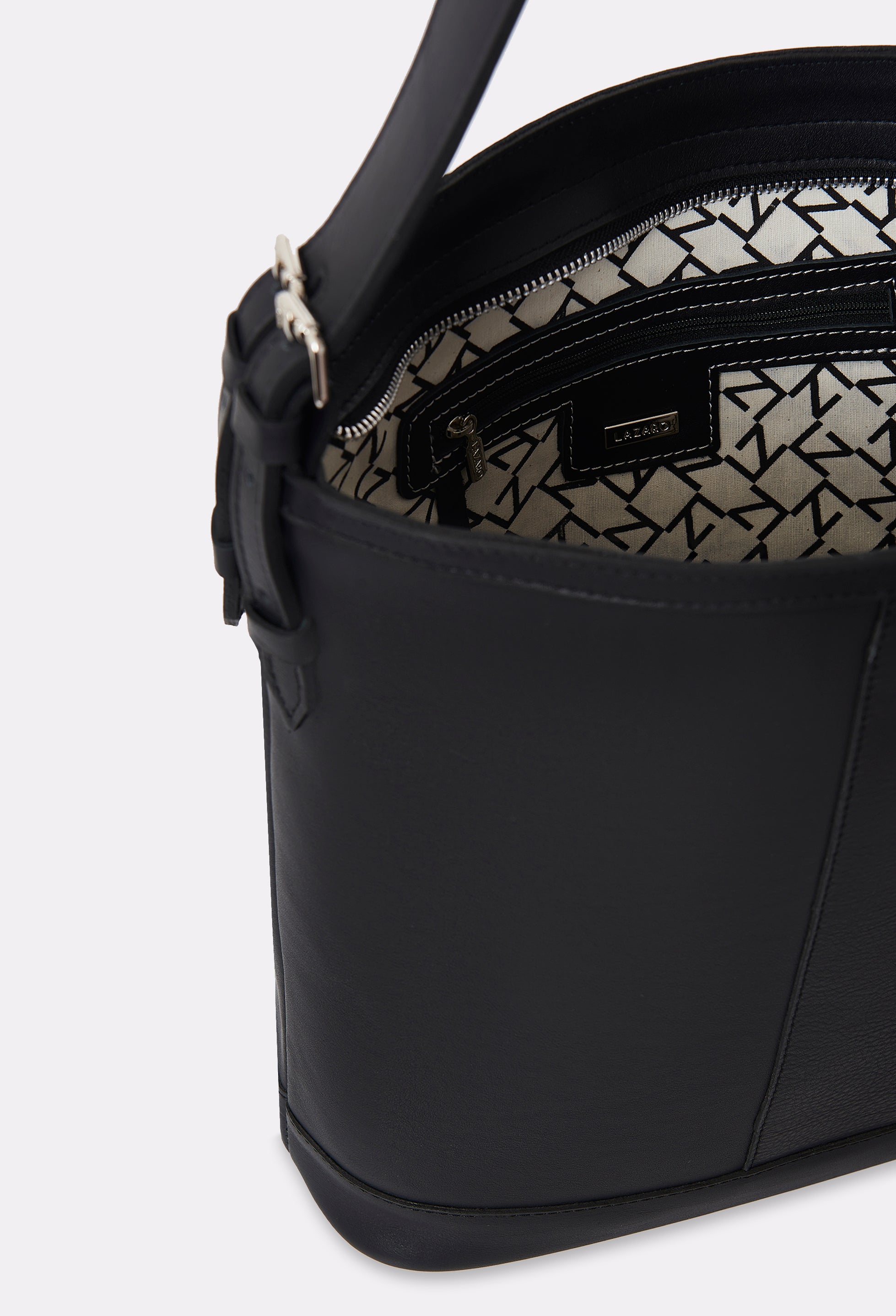 Partial photo of the interior of a Black Leather Tote Bag Montana with a main zippered compartment with Lazaro patterned lining and an internal zippered pocket.