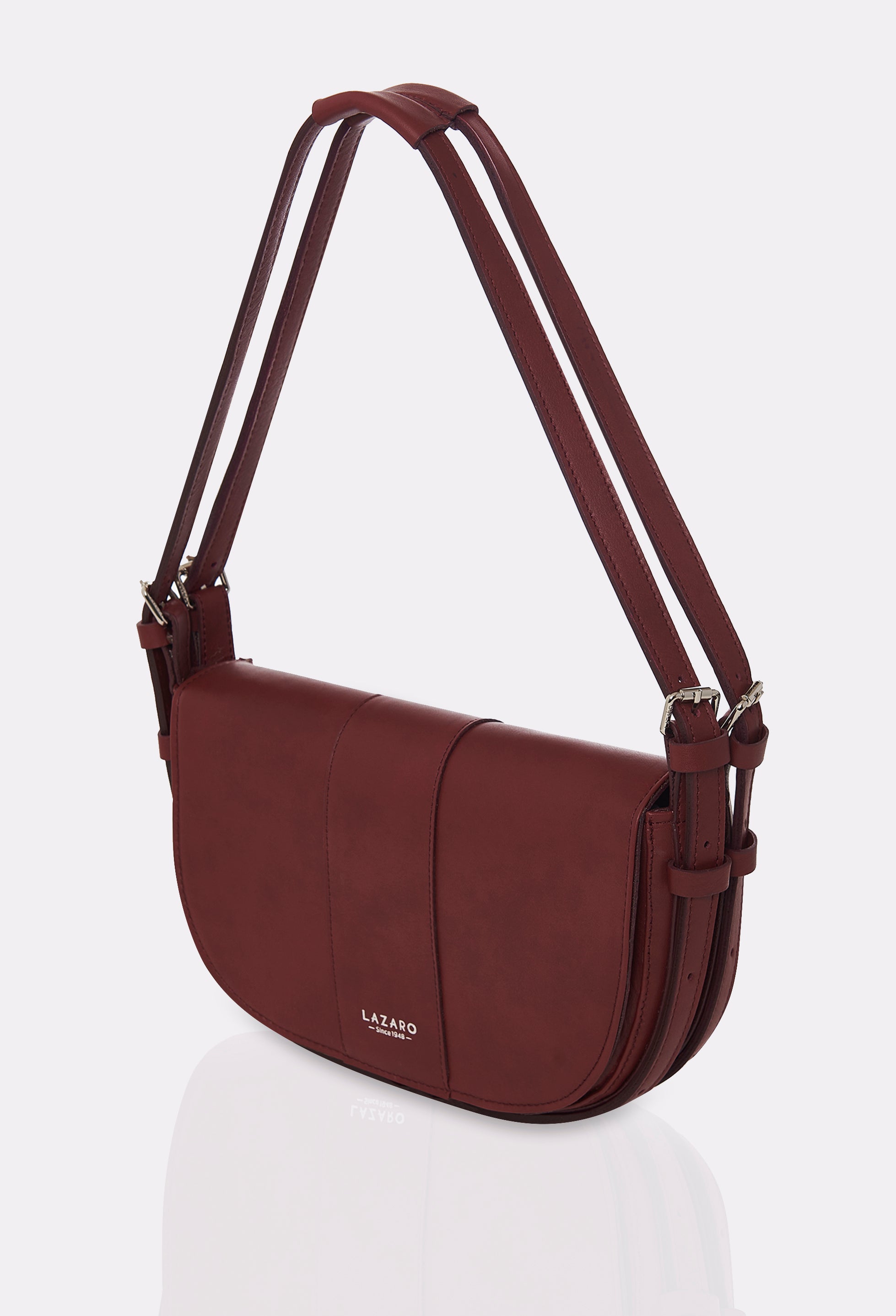 Side of a Burgundy Leather Shoulder Bag Montana with double leather strap, equipped with metal buckles and cufflinks and silver embossed Lazaro logo.