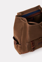 Partial photo of a Coffee Canvas Backpack with leather details, a main compartment and distressed antiqued bronze fittings.