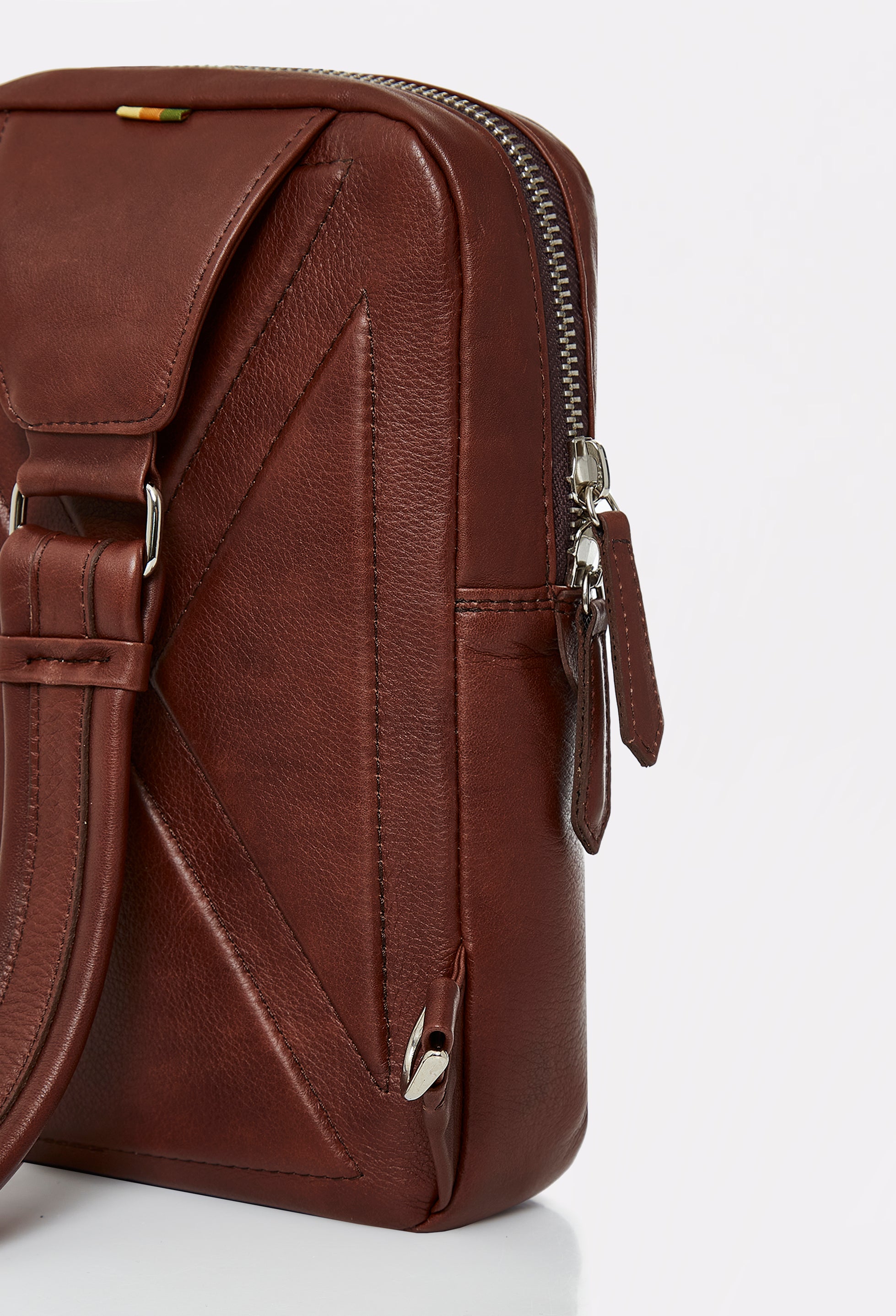 Partial photo of a Coffee Leather Sling Bag Salerno with ergonomically shaped rear and a leather padded and adjustable strap.