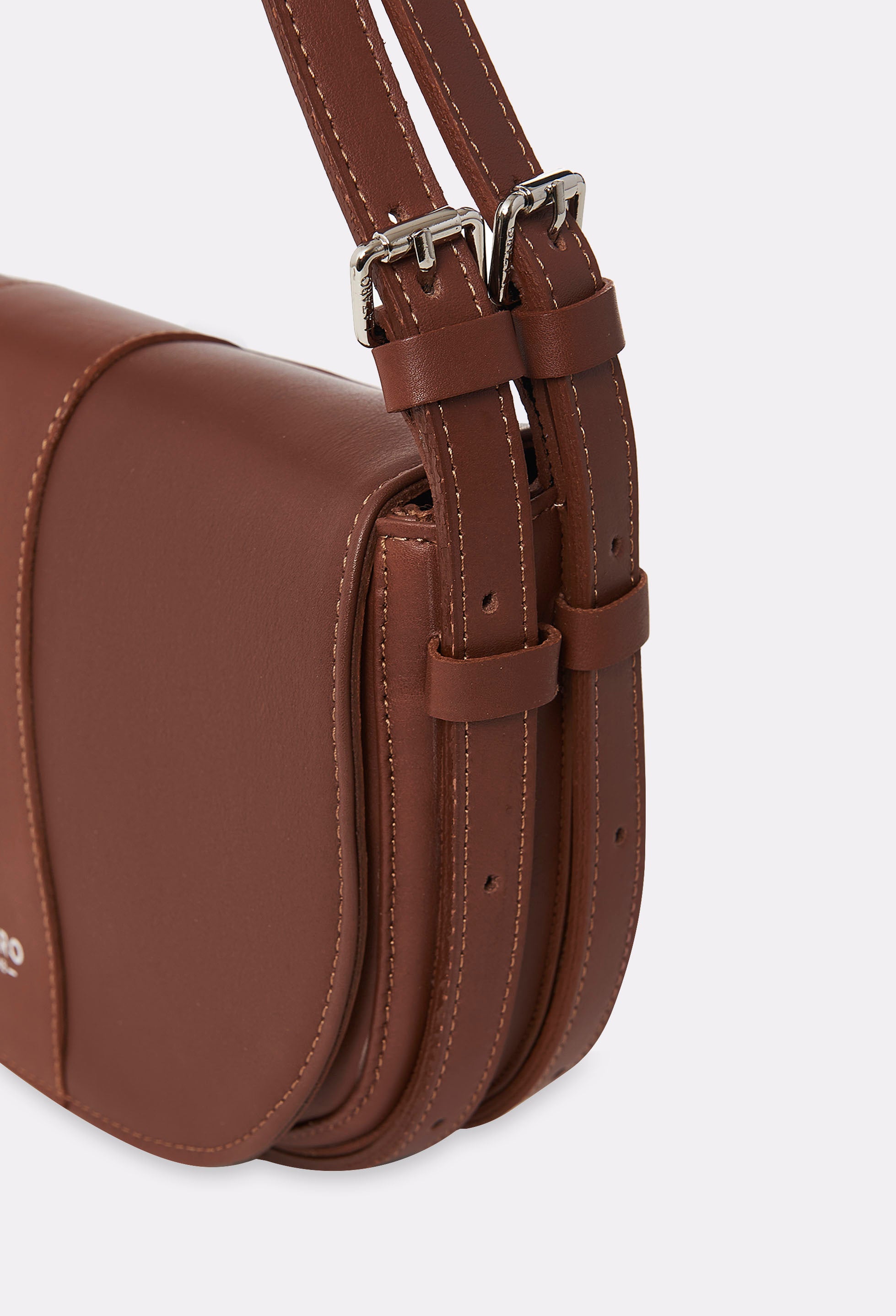 Partial photo of a Cognac Leather Shoulder Bag Montana with silver embossed Lazaro logo and double leather strap, equipped with metal buckles and cufflinks.