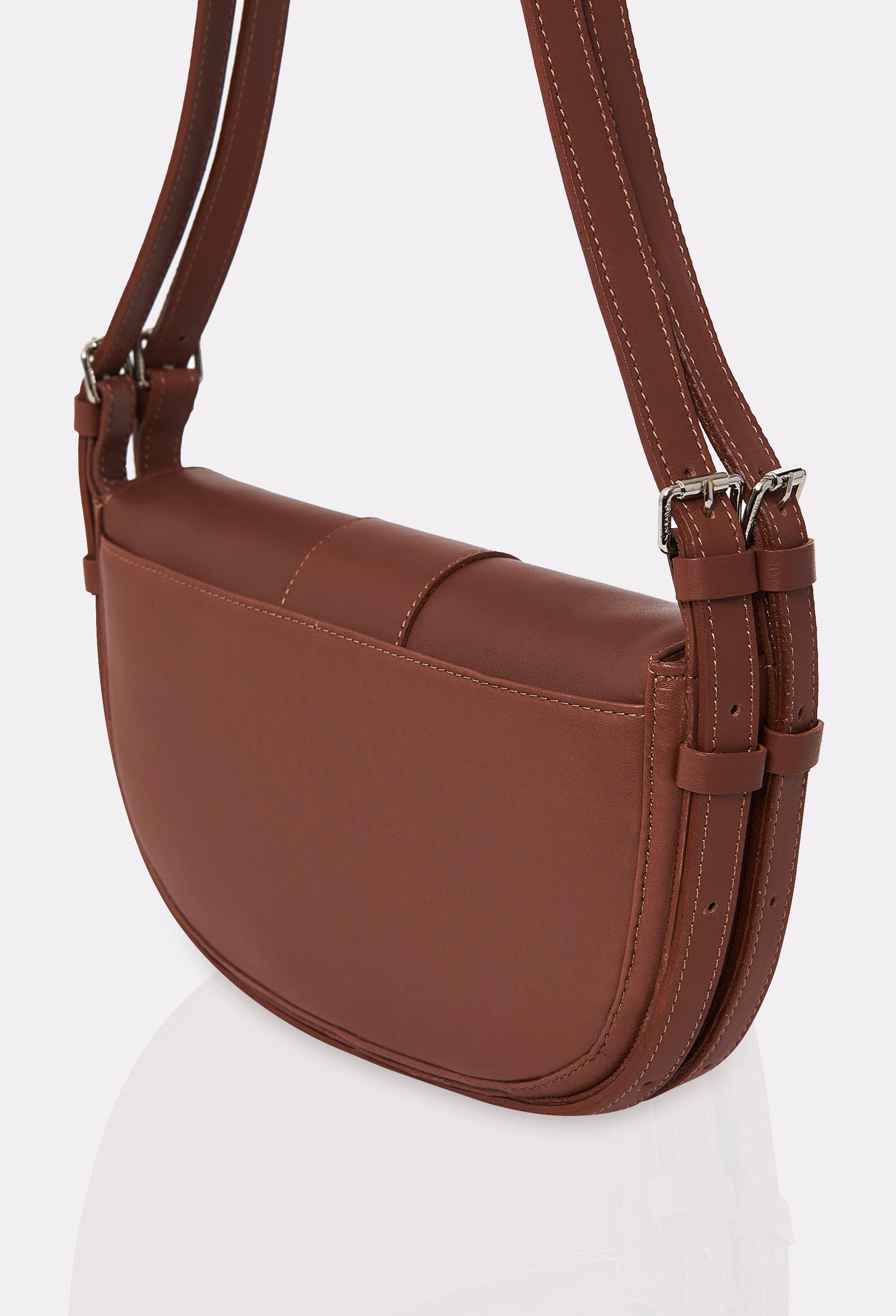 Rear of a Cognac Leather Shoulder Bag Montana with a double leather strap and an external multifunctional pocket.