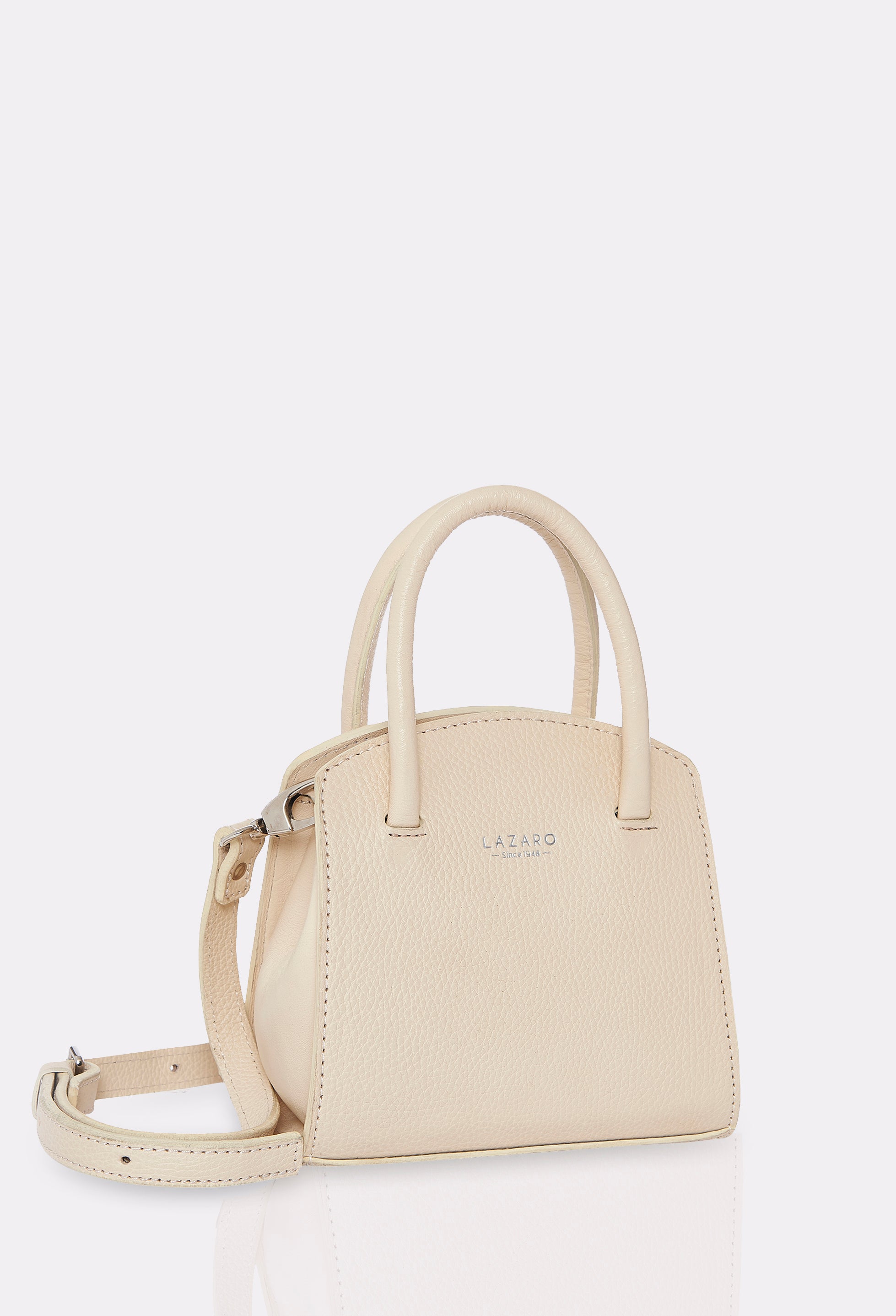 Side of a Off White Leather Mini Bag Margot with a leather adjustable and detachable strap and silver embossed Lazaro logo.