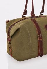 Partial photo of a Olive Canvas Duffel Bag with leather handles, a zippered main compartment, and distressed antiqued bronze fittings.