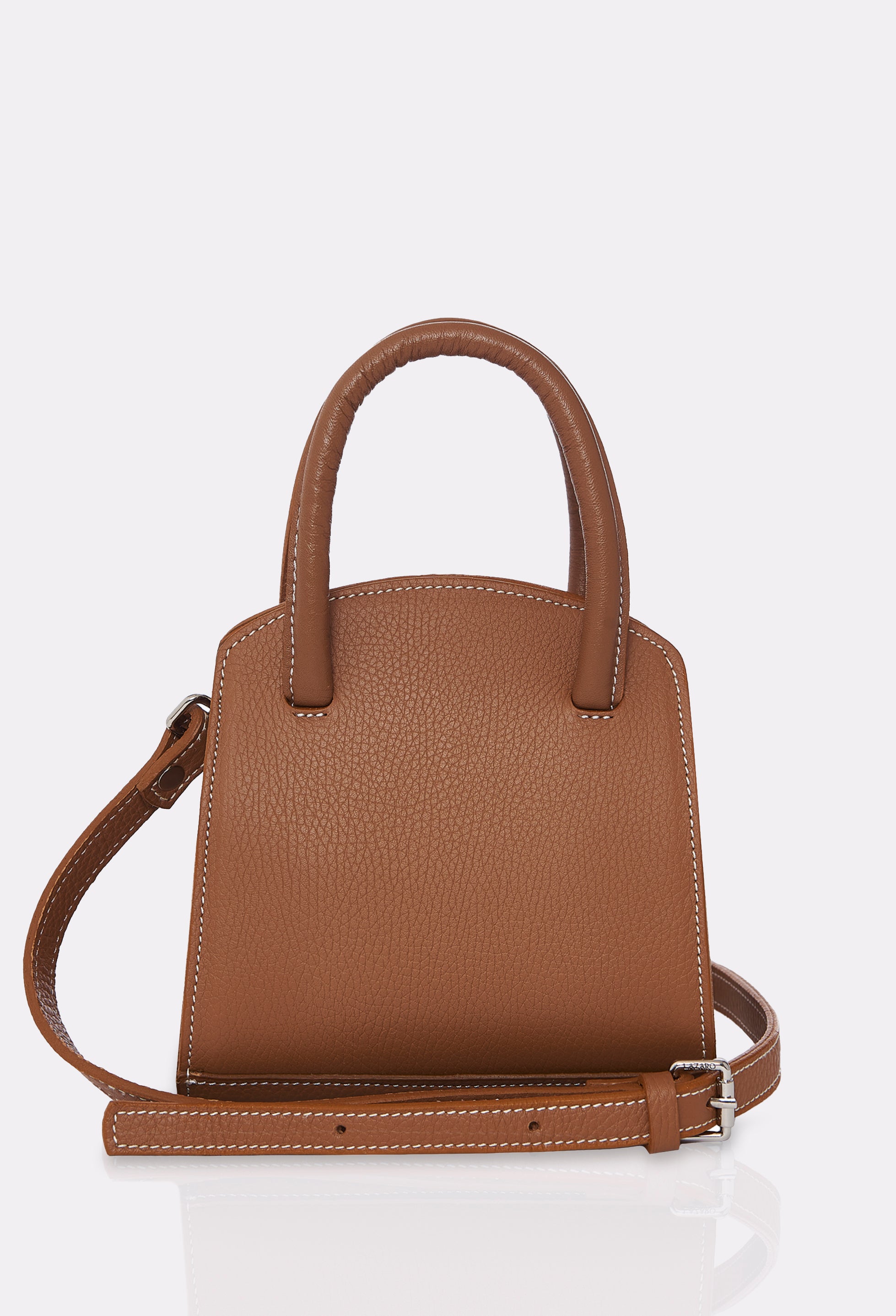 Rear of a Tan Leather Mini Bag Margot with a leather adjustable and detachable strap and contrast stitching highlights.