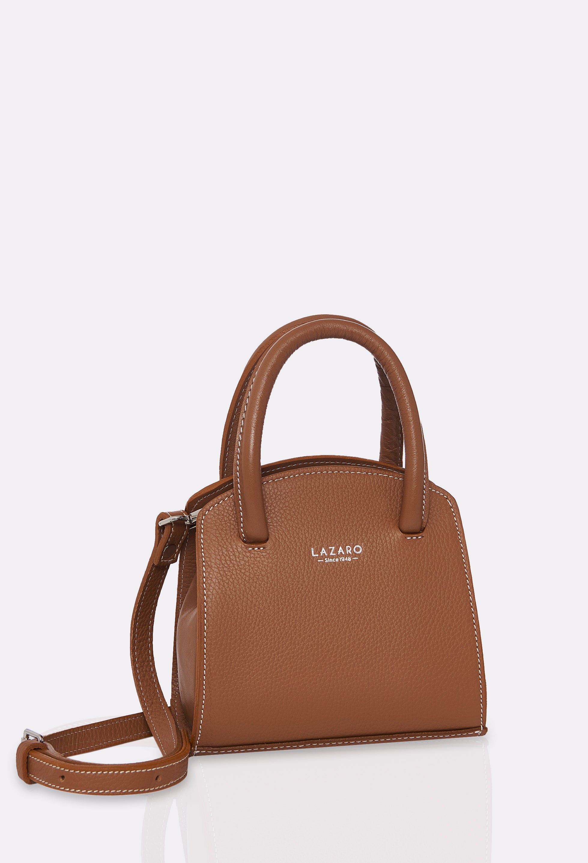 Side of a Tan Leather Mini Bag Margot with a leather adjustable and detachable strap, silver embossed Lazaro logo and contrast stitching highlights.