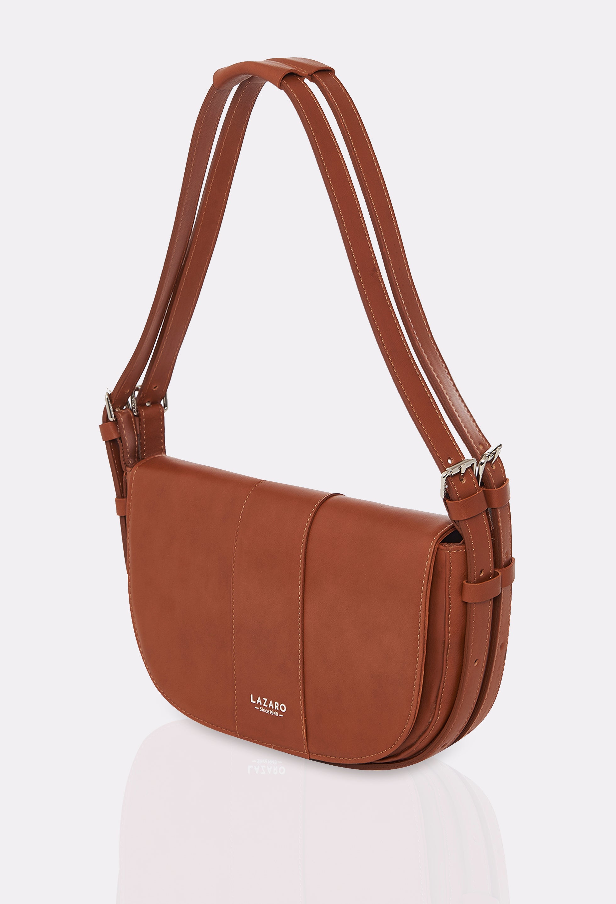 Side of a Tan Leather Shoulder Bag Montana with double leather strap, equipped with metal buckles and cufflinks and silver embossed Lazaro logo.