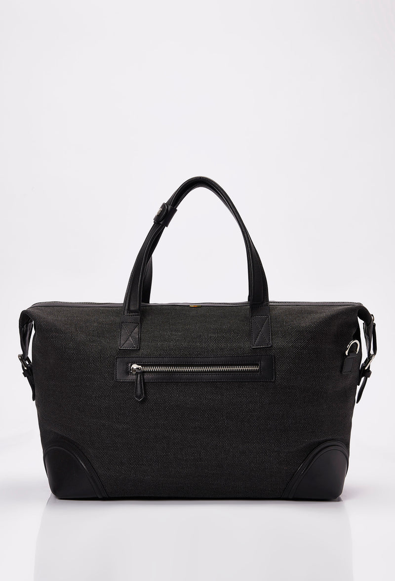 Rear of a Black Large Canvas Duffel Bag that shows a zippered pocket and leather handles.