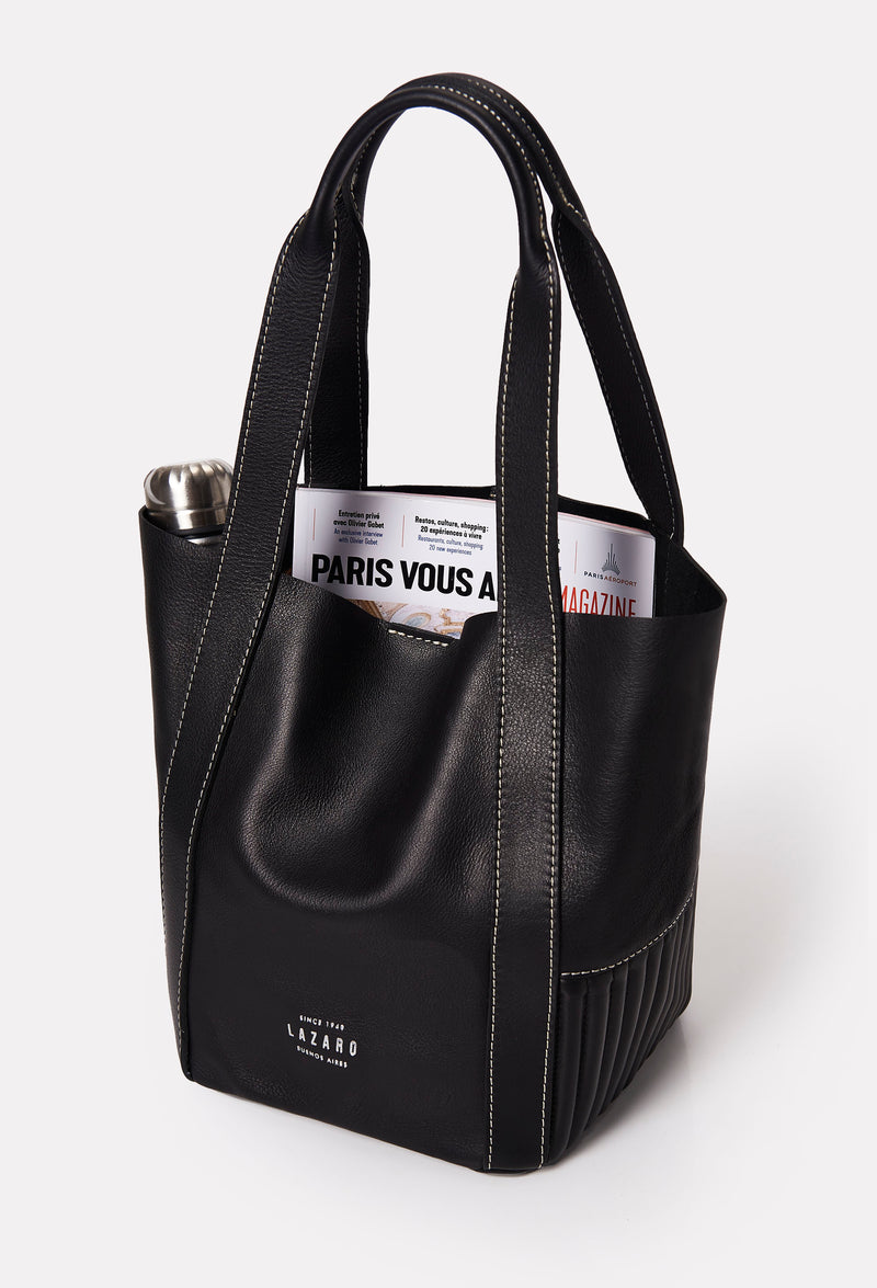 Interior of a Black Leather Mini Bucket Bag Ushuaia that shows the bag fits a magazine and a water bottle.