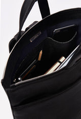 Interior of a Black Leather Tote Backpack that shows a zippered main compartment, a front zippered pocket and an internal cell phone pocket and card holder. 