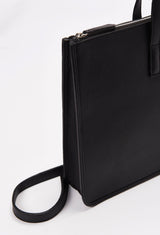 Partial photo of a Black Leather Slim Briefcase with a detachable leather strap and a main zippered compartment.