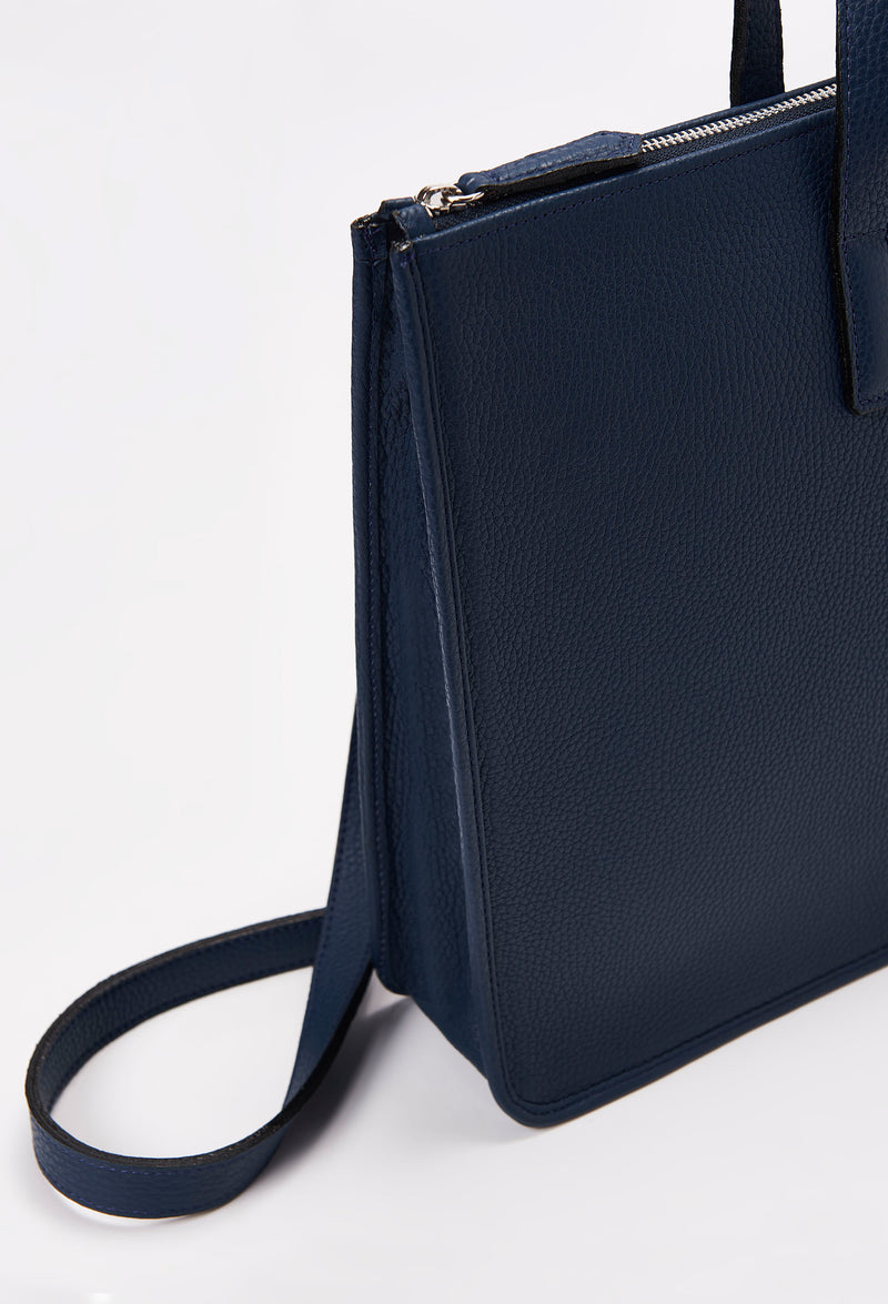 Partial photo of a Blue Leather Slim Briefcase with a detachable leather strap and a main zippered compartment.