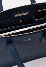 Interior photo of a Blue Leather Slim Briefcase showing its main zippered compartment packed with a computer, internal multifunctional pockets and Lazaro silver ironwork.
