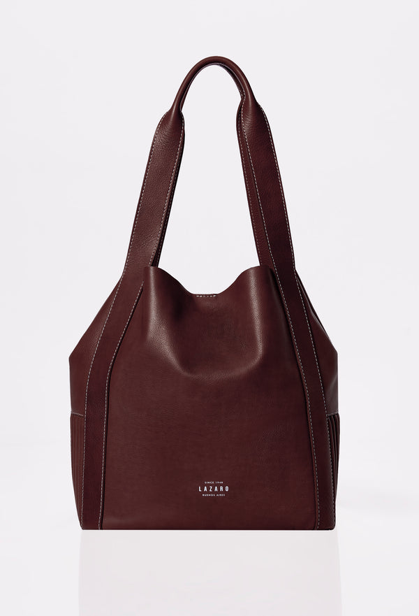 Front of a Coffee Leather Bucket Bag Ushuaia with Lazaro logo and contrast stitching highlights.