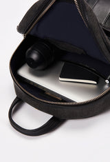 Interior of a Black Lightweight Canvas Zipper Backpack that shows a zippered main compartment and an internal cell phone pocket packed with a computer, a water bottle, a notebook and a pen.