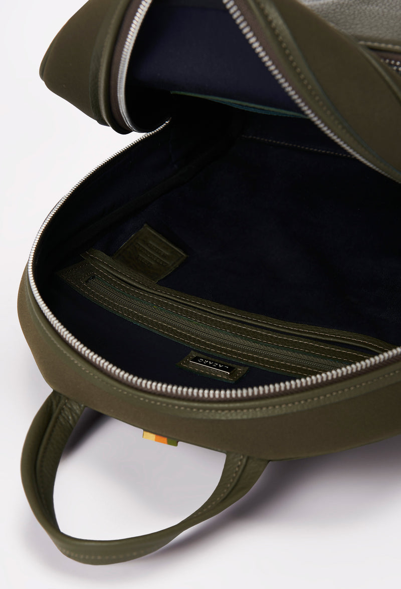 Interior of a Olive Neoprene and Leather Backpack that shows a main compartment with an internal zippered pocket.