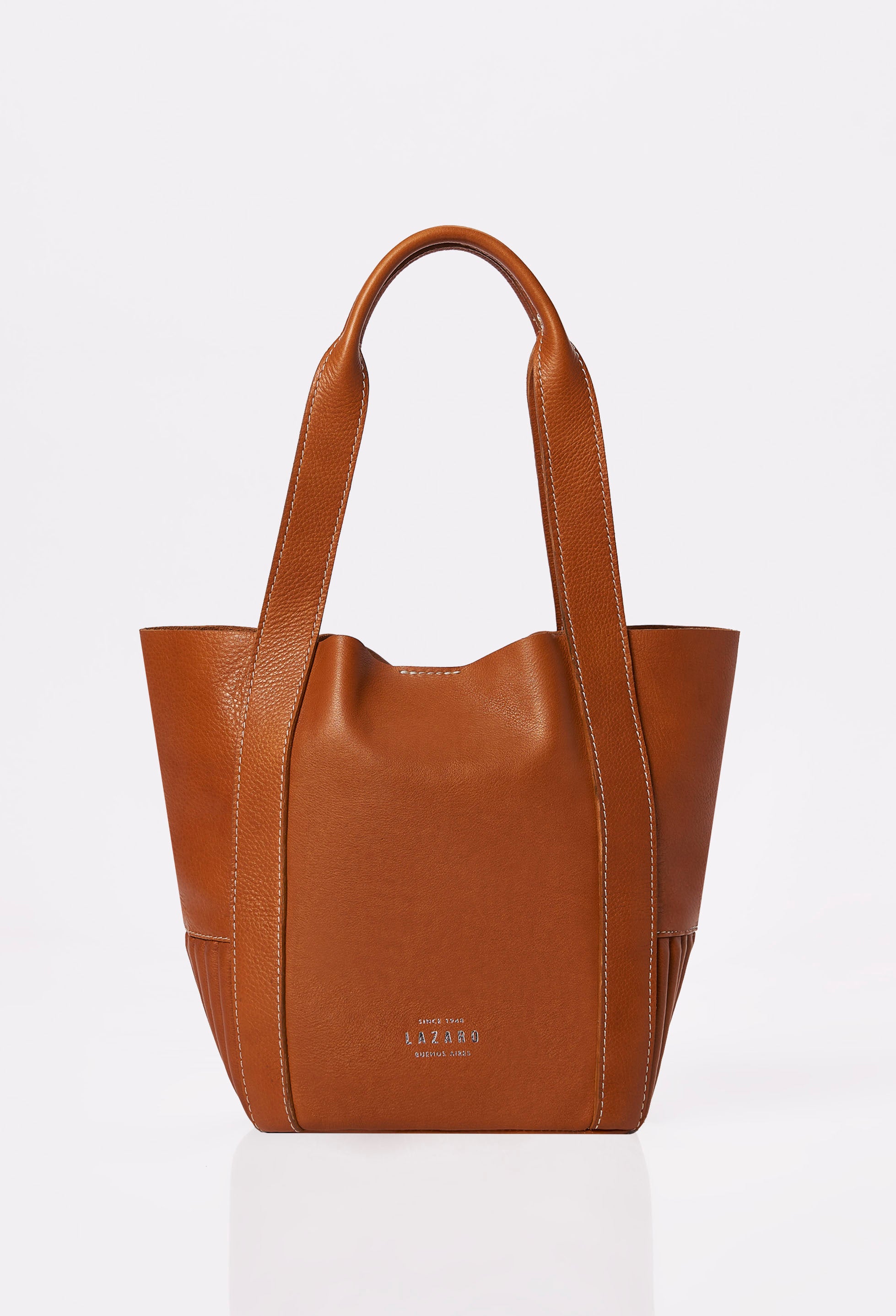 Front of a Tan Leather Mini Bucket Bag Ushuaia with Lazaro logo and contrast stitching highlights.